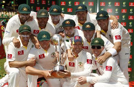 The Australian team pose with the Border-Gavaskar Trophy after winning the series 4-0 against India in Adelaide